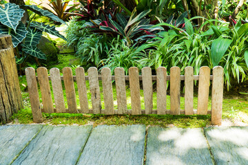 Wooden fence decoration in the garden background. Vertical wood fence decorative in ornamental garden.