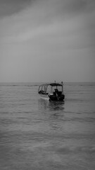 Black and white of an speed boat for tourist on blue sea at Perhentian Island, Malaysia. Calm and tranquil environment. Tropical ocean for travel. Selective focused on foreground. Small waves.