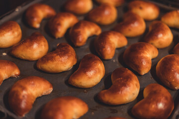 Traditional Latvian homemade yeast dough patties with bacon. Fresh baked pies or patties, closeup.