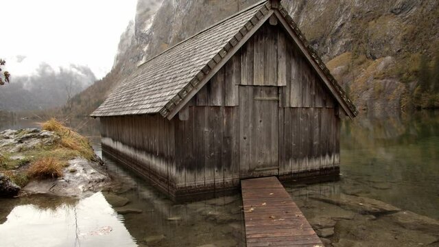 Lake wooden cabin on a foggy morning in the lake of k&ouml;nigssee