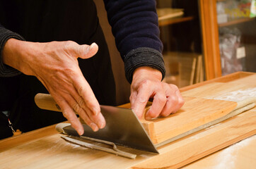 woman cutting soba noodles