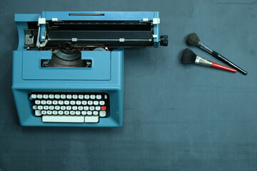 macchina da scrivere su lavagna con pennelli per il make up