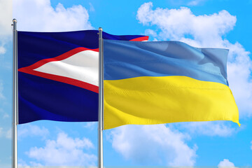 Ukraine and American Samoa national flag waving in the windy deep blue sky. Diplomacy and international relations concept.