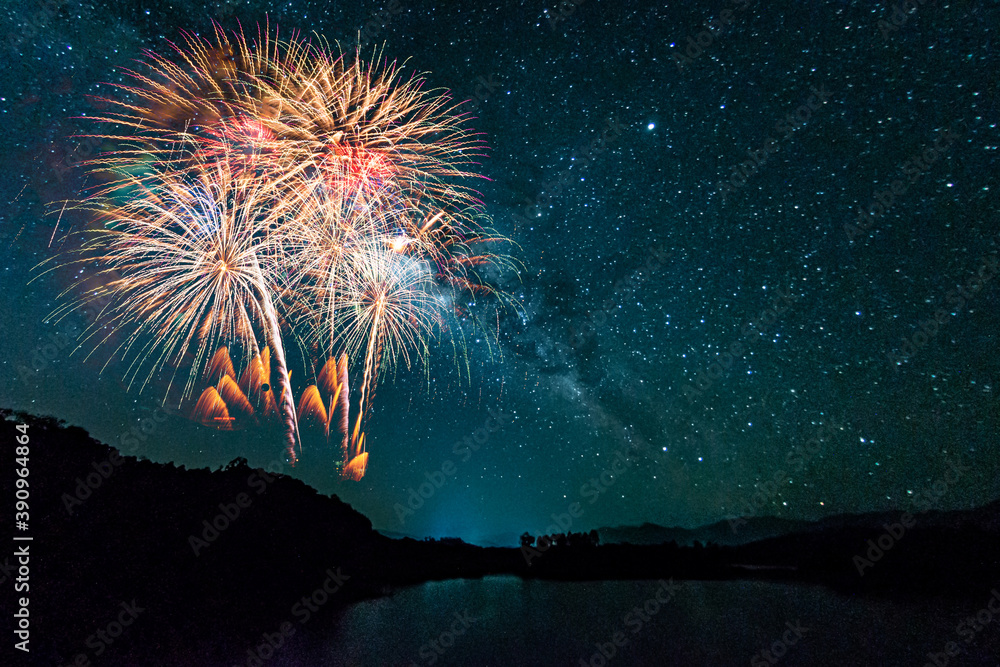 Wall mural colorful of fireworks display on milkyway in night sky background.
