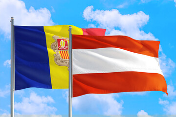 Austria and Andorra national flag waving in the windy deep blue sky. Diplomacy and international relations concept.