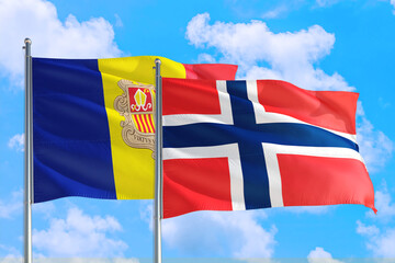 Bouvet Islands and Andorra national flag waving in the windy deep blue sky. Diplomacy and international relations concept.