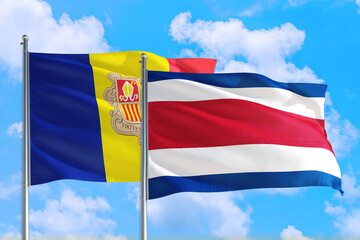 Costa Rica and Andorra national flag waving in the windy deep blue sky. Diplomacy and international relations concept.