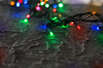 Multicolored garland on a black textured background.