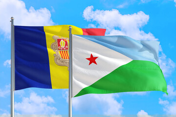 Djibouti and Andorra national flag waving in the windy deep blue sky. Diplomacy and international relations concept.