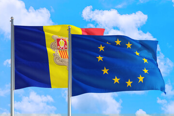 European Union and Andorra national flag waving in the windy deep blue sky. Diplomacy and international relations concept.