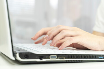 girl's hands on the laptop keyboard