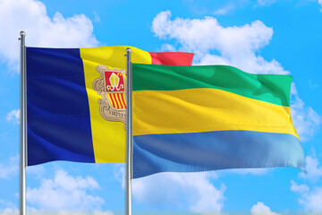 Gabon and Andorra national flag waving in the windy deep blue sky. Diplomacy and international relations concept.