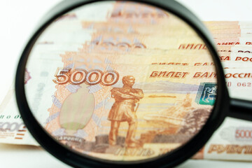 magnifying glass and Russian money