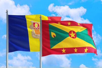 Grenada and Andorra national flag waving in the windy deep blue sky. Diplomacy and international relations concept.