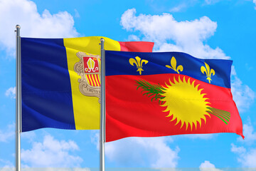 Guadeloupe and Andorra national flag waving in the windy deep blue sky. Diplomacy and international relations concept.