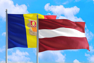 Latvia and Andorra national flag waving in the windy deep blue sky. Diplomacy and international relations concept.