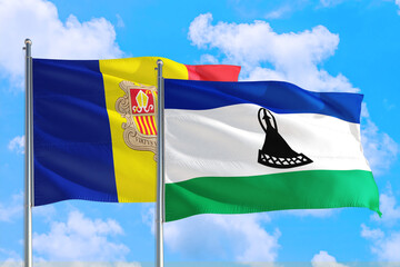 Lesotho and Andorra national flag waving in the windy deep blue sky. Diplomacy and international relations concept.