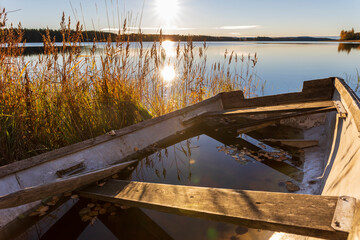 Reflection of railing on lake against sky