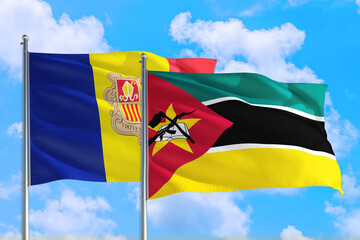 Mozambique and Andorra national flag waving in the windy deep blue sky. Diplomacy and international relations concept.
