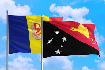 Papua New Guinea and Andorra national flag waving in the windy deep blue sky. Diplomacy and international relations concept.