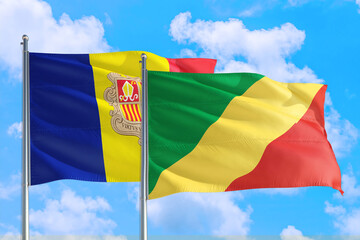 Republic Of The Congo and Andorra national flag waving in the windy deep blue sky. Diplomacy and international relations concept.
