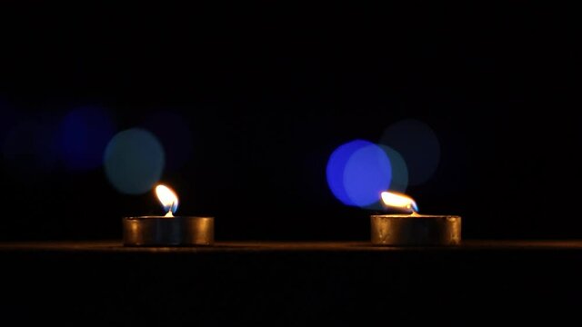Closeup shot of diyas in front of the decorated house with light during the diwali festival in India