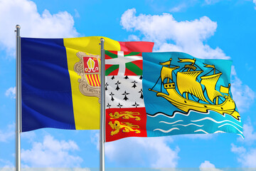 Saint Pierre And Miquelon and Andorra national flag waving in the windy deep blue sky. Diplomacy and international relations concept.
