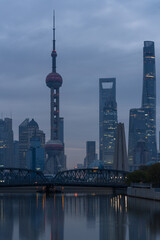 Fototapeta premium Sunrise view of Lujiazui, the financial district in Shanghai, China, on a cloudy day.