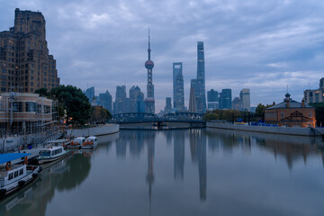 Fototapeta na wymiar Sunrise view of Lujiazui, the financial district in Shanghai, China, on a cloudy day.