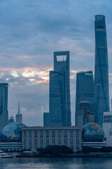 Fototapeta na wymiar Sunrise view of Lujiazui, the financial district in Shanghai, China, on a cloudy day.