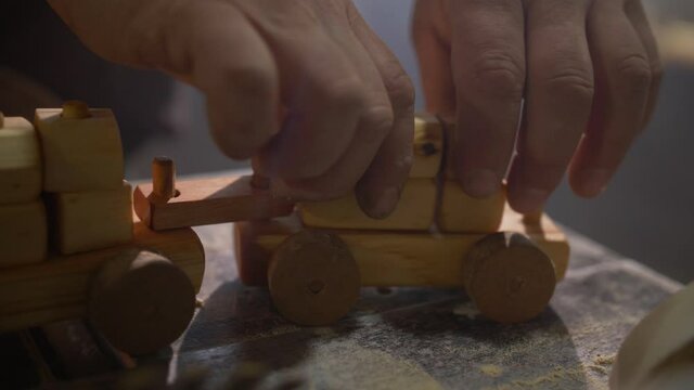 Adult Hands Building a Wood Train