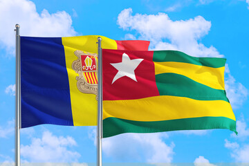 Togo and Andorra national flag waving in the windy deep blue sky. Diplomacy and international relations concept.
