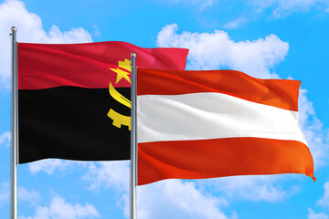 Austria and Angola national flag waving in the windy deep blue sky. Diplomacy and international relations concept.