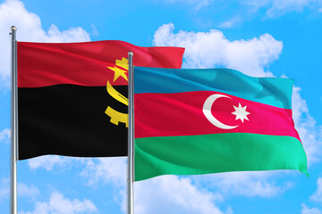 Azerbaijan and Angola national flag waving in the windy deep blue sky. Diplomacy and international relations concept.