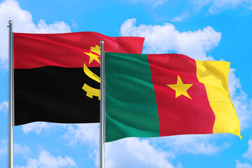 Cameroon and Angola national flag waving in the windy deep blue sky. Diplomacy and international relations concept.