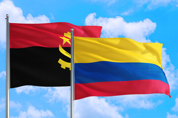 Colombia and Angola national flag waving in the windy deep blue sky. Diplomacy and international...