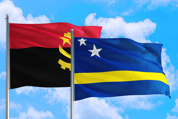 Curacao and Angola national flag waving in the windy deep blue sky. Diplomacy and international relations concept.