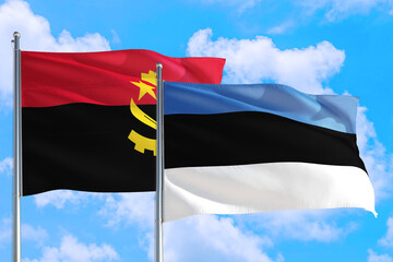 Estonia and Angola national flag waving in the windy deep blue sky. Diplomacy and international relations concept.