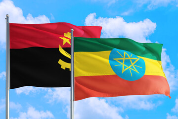 Ethiopia and Angola national flag waving in the windy deep blue sky. Diplomacy and international relations concept.