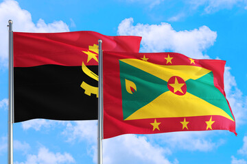 Grenada and Angola national flag waving in the windy deep blue sky. Diplomacy and international relations concept.