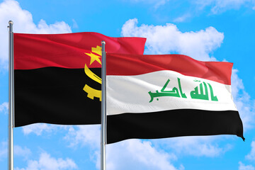 Fototapeta na wymiar Iraq and Angola national flag waving in the windy deep blue sky. Diplomacy and international relations concept.