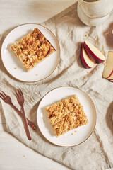 Top view of delicious homemade apple cake with crumble on a white table