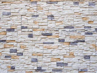 Frontal view of a wall with decorative masonry. Background texture. Full screen