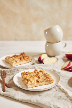 Homemade apple cake with crumble on a white table