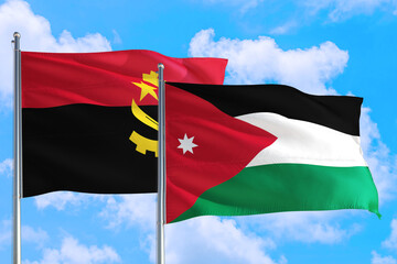 Jordan and Angola national flag waving in the windy deep blue sky. Diplomacy and international...
