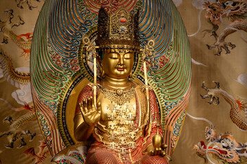 Golden Buddha statue inside the Buddha Tooth Relic Temple in Chinatown District, Singapore.