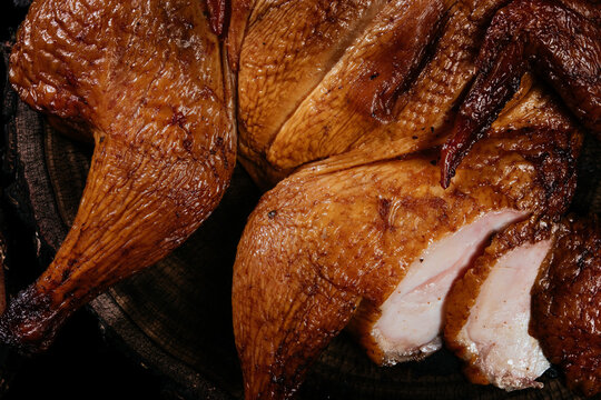 Golden, fresh, appetizing whole chicken cooked on smoke, grill, BBQ. Snacks for beer, for gourmets. Natural healthy homemade food.