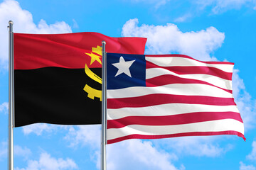 Liberia and Angola national flag waving in the windy deep blue sky. Diplomacy and international relations concept.