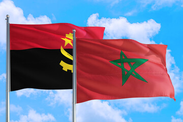 Morocco and Angola national flag waving in the windy deep blue sky. Diplomacy and international...