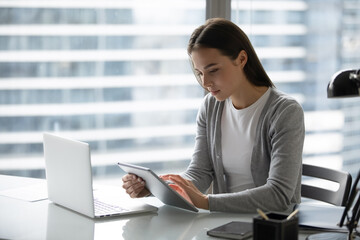 Modern office worker. Concentrated focused young businesswoman employee manager doing electronic...